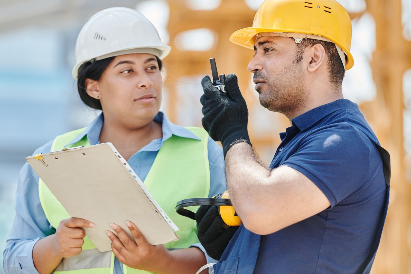 Construction workers wearing hard hats on site
