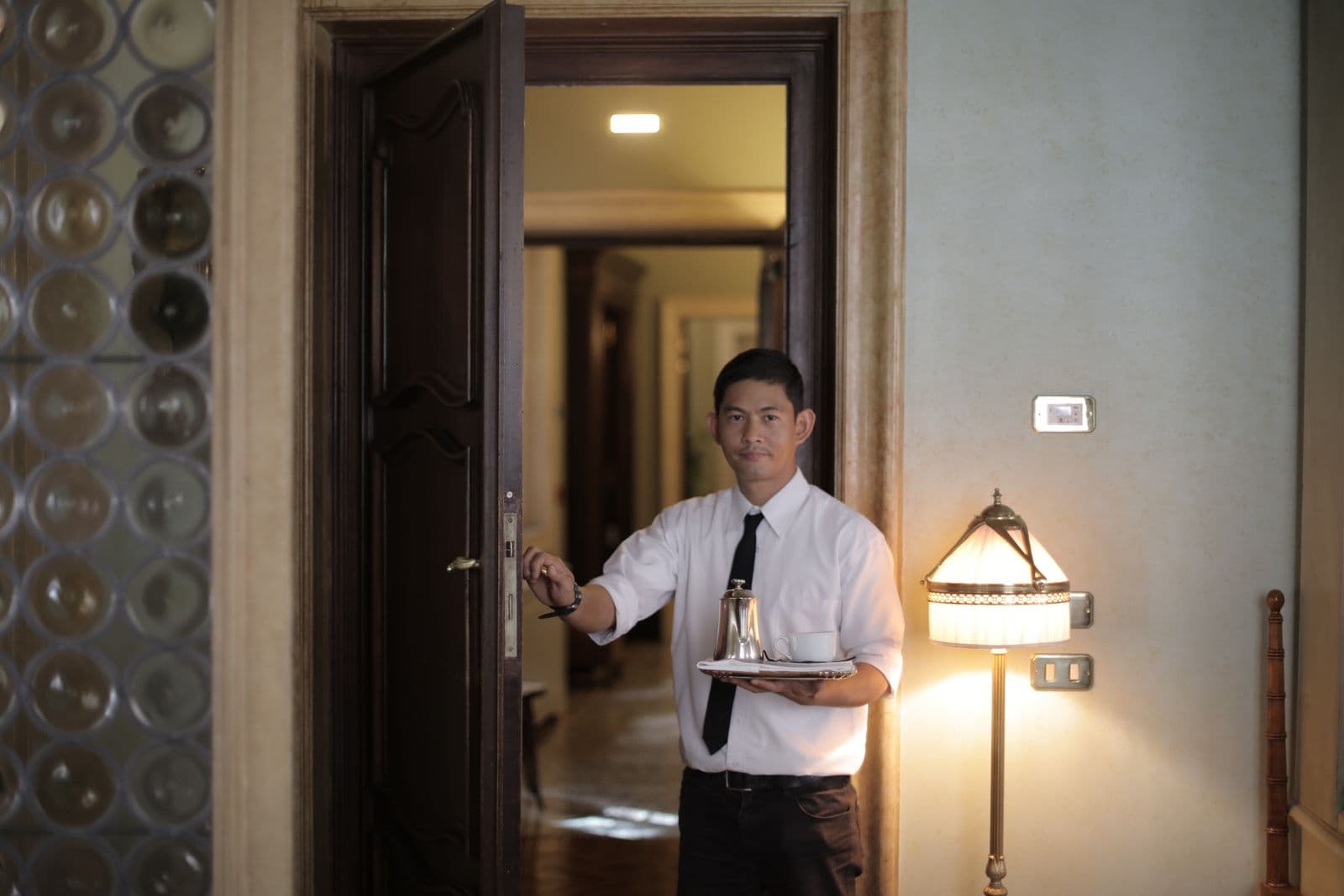 Hotel staff attending to guests in a hallway