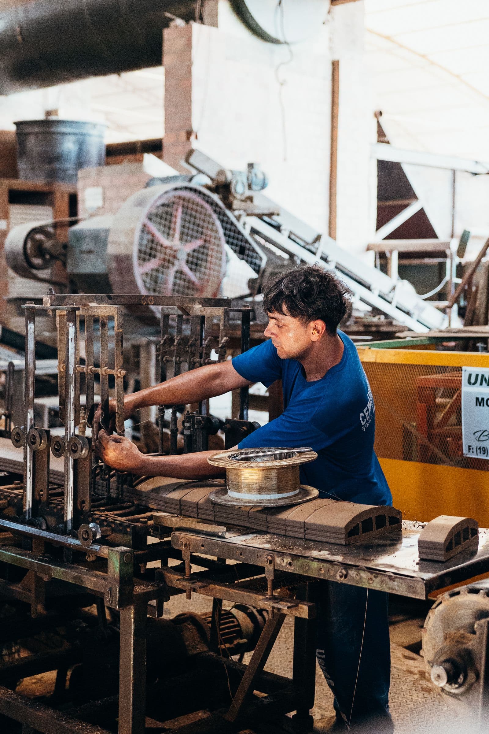 An industrial worker operating factory machinery