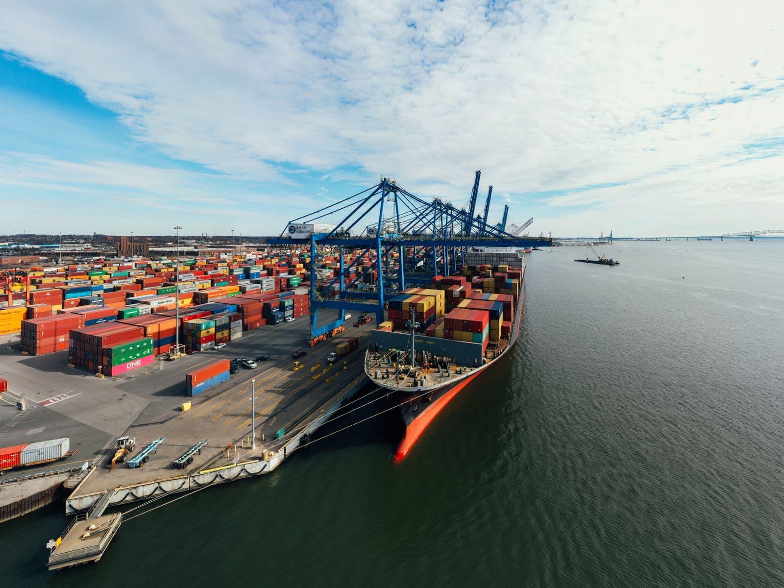 A cargo ship being unloaded at a container port