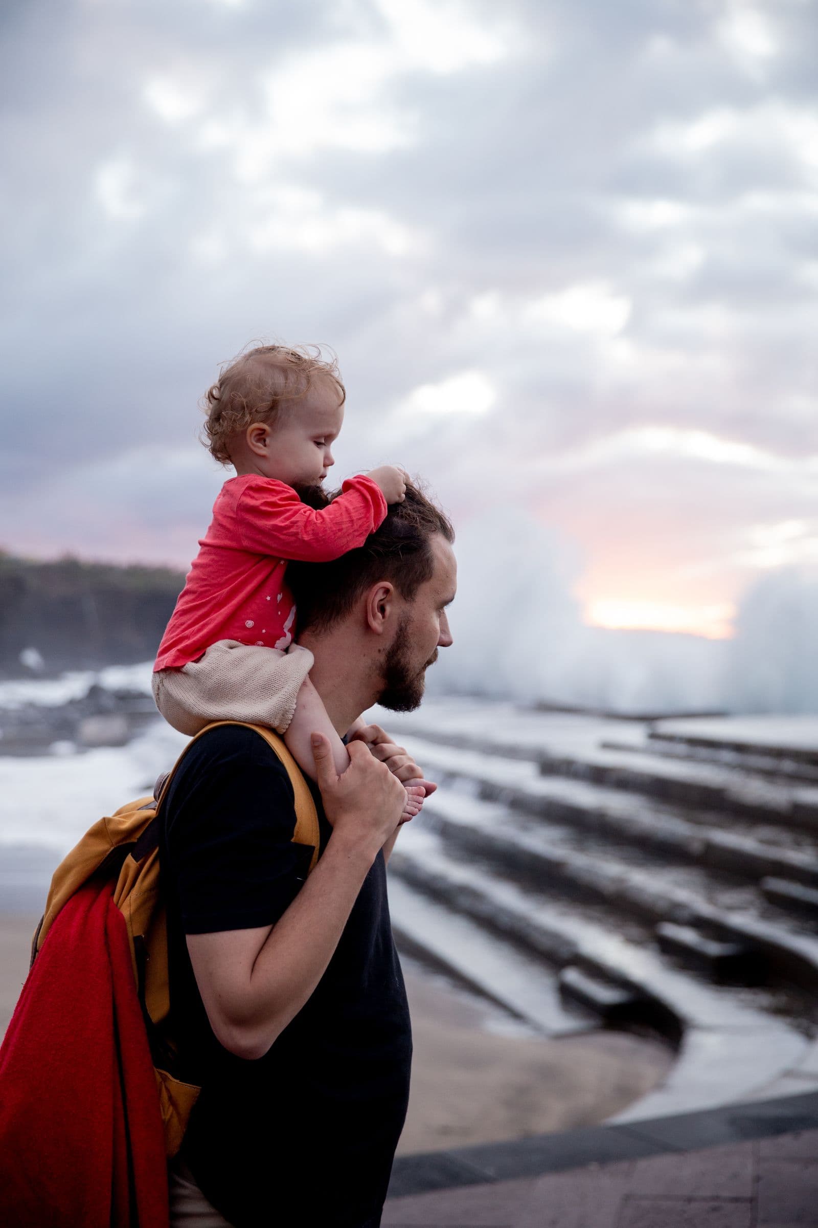A father carrying his child on his shoulders