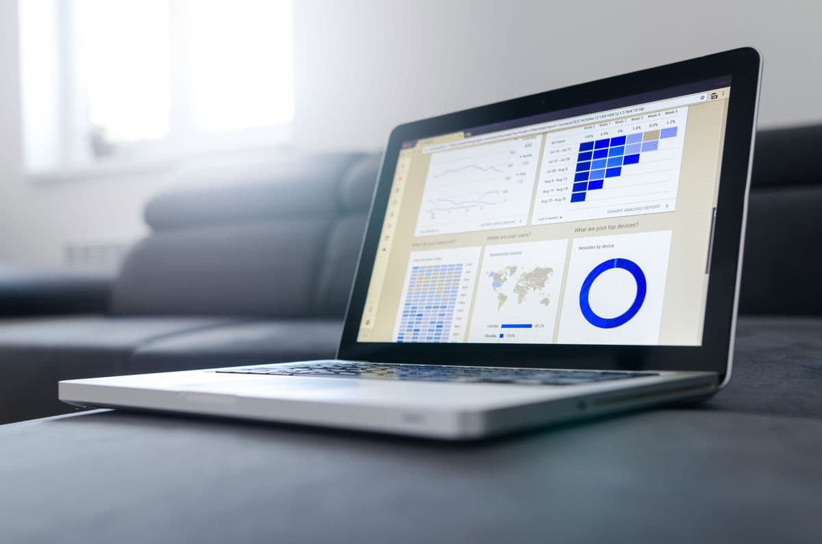 A professional reviewing dashboard charts on a laptop.